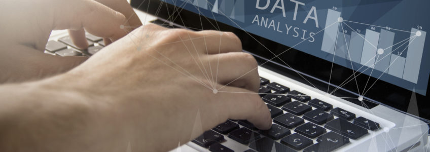 Man looking at data analytics and visualization tools on computer
